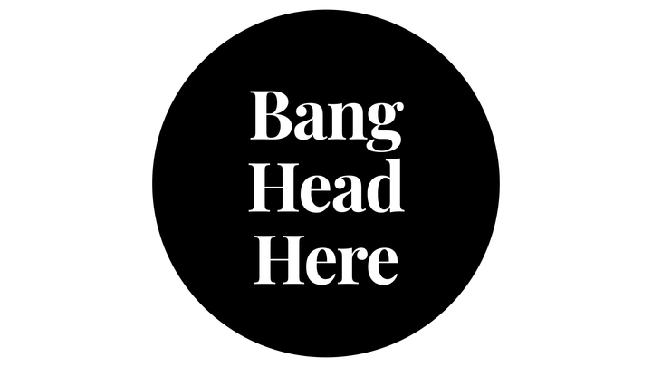 black circle with white writing that says "Bang Head Here"